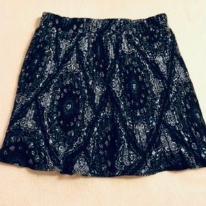 Mini skirt with sheer overlay pattern and elastic waist. Small by American Rag
